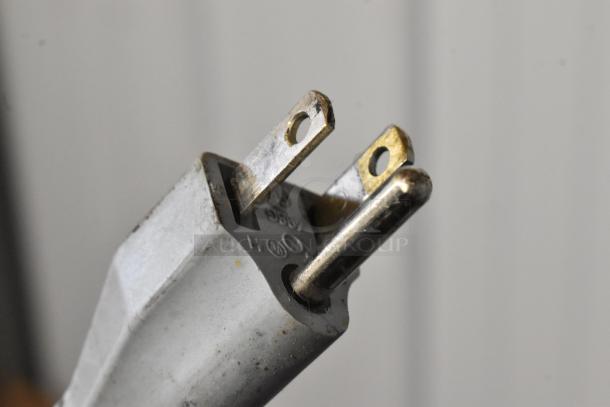 Close-up of a power plug for a Bizerba GSP H meat slicer, showing minor wear on metal prongs. 120 volts, 1 phase.