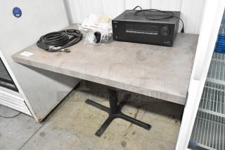 Dining height table with contents including an Onkyo AV receiver, coiled cables, and miscellaneous items, in good condition.