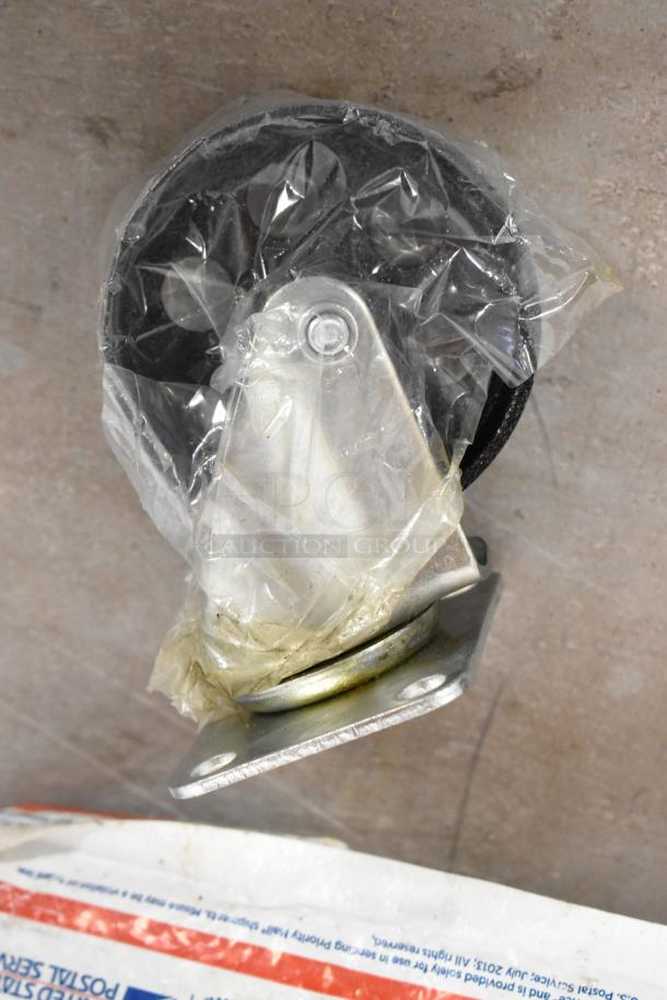 Caster wheel wrapped in plastic, attached to a bracket, on a concrete surface.