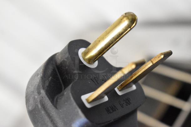 Close-up of the plug on a Vollrath JT3H CT4H-220950 electric conveyor toaster oven, showing NEMA 6-30P markings.
