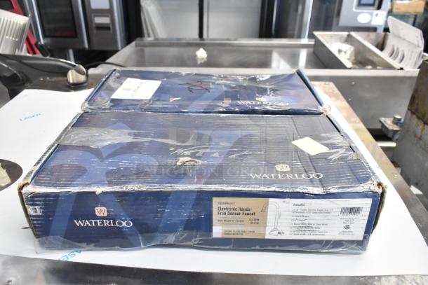 Two boxes of Waterloo sensor faucets, models 750EFWM448LF and 750EFDMHSBZ12LF, new, scratch and dent, visible packaging wear.