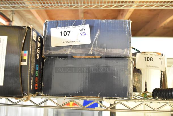 Two boxes of Waterloo sensor faucets, new scratch and dent, labeled for auction, visible tags show "107 QTY x2" and "108 QTY 1".