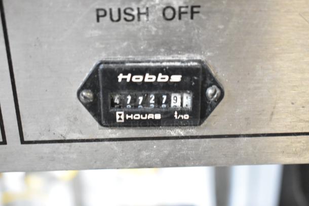 BE&SCO Beta 900 tortilla press/oven, Hobbs hour meter showing 477279 hours, stainless steel, natural gas-powered.