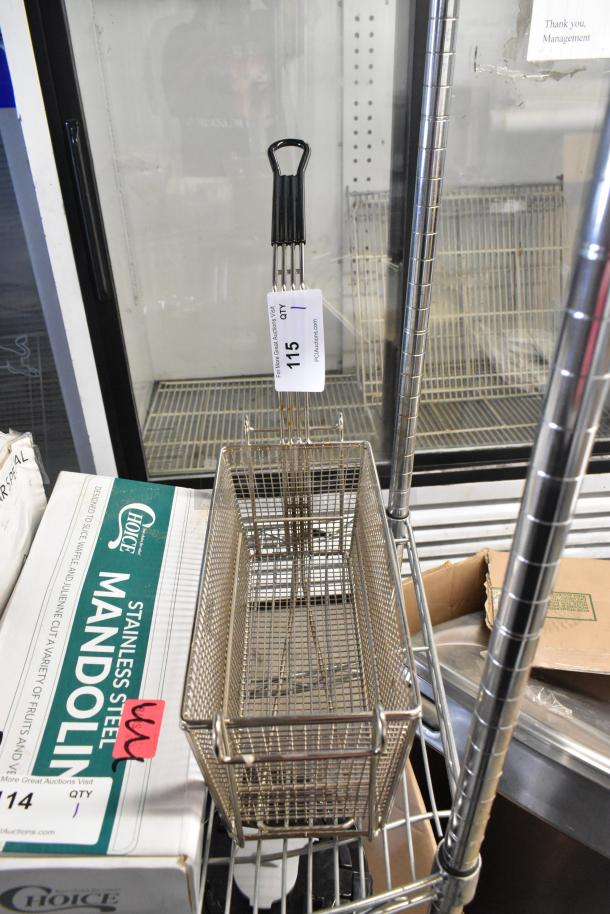 Brand new metal fry basket, minor scratches and dents, with black handle and lot tag number 115.