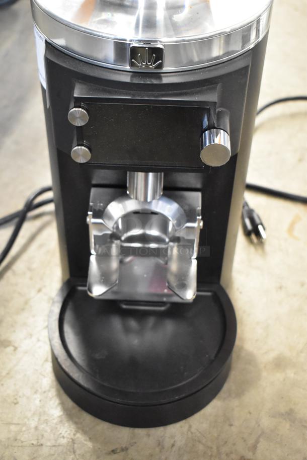 Brand new 2024 Mahlkonig E65W GBS 2.6 lb black espresso grinder with visible scratches and dents, 120V, 1 Phase.