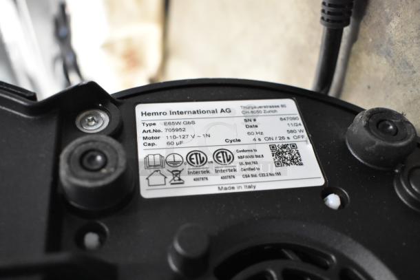 Label on Mahlkonig E65W GBS espresso grinder showing type, motor specs, and certification details. Made in Italy.