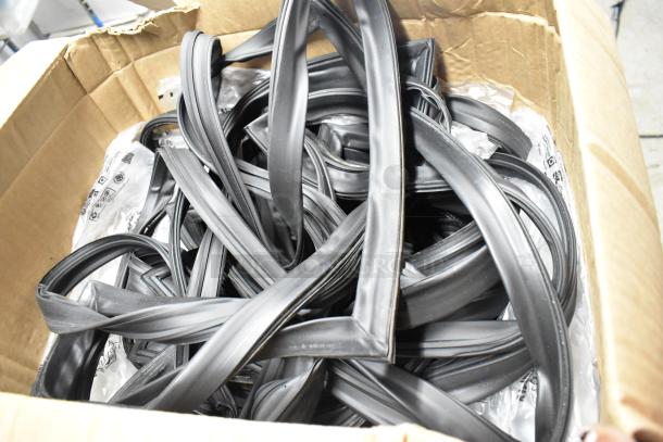 Box of black door seals in a cardboard box, used for insulation. Seals appear in new condition, suitable for various door types.