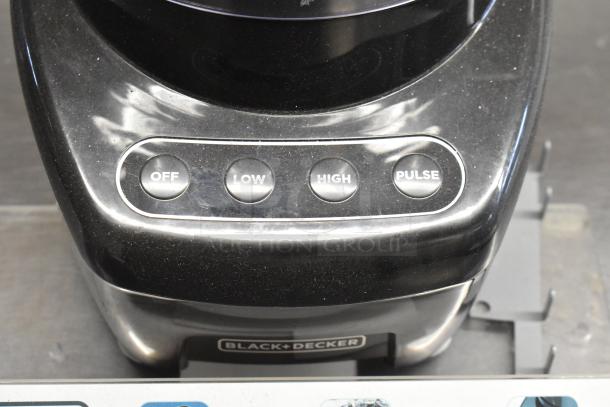Black & Decker food processor with buttons labeled Off, Low, High, Pulse. Display unit, visible wear, model information unclear.