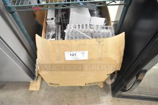 Box of assorted items, including shelves, visible in a worn cardboard box. Label reads "PCI Auctions, Item 121, Qty 1."