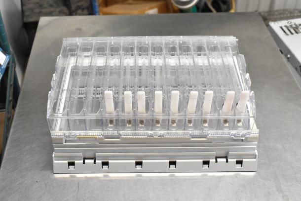 Box with clear plastic shelves, featuring adjustable white dividers. Condition appears good with no visible damage.