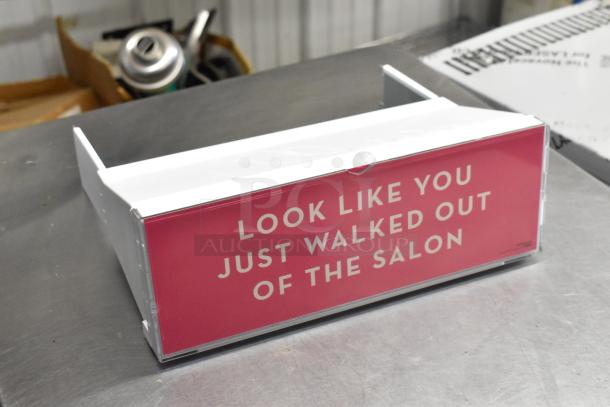 Box of various salon display shelves with a pink front panel reading "LOOK LIKE YOU JUST WALKED OUT OF THE SALON."