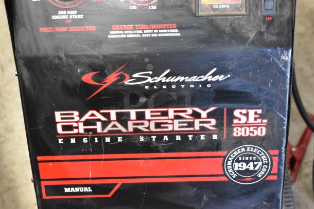 Schumacher SE 8050 Battery Charger, black with red and white branding, manual operation, charger's worn condition.