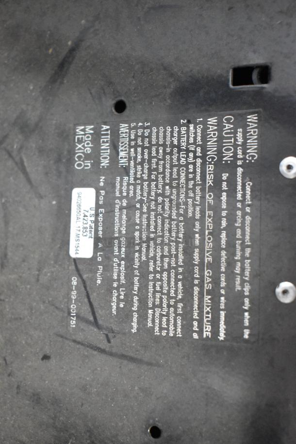 Schumacher SE 8050 Battery Charger backside with safety instructions, "Made in Mexico" label, and U.S. patent number visible.