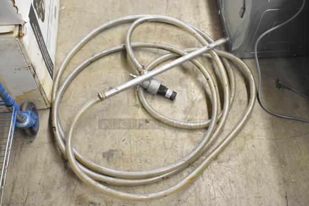 Two coiled metal hoses with connectors, used condition. Bid doubles for this auction item.