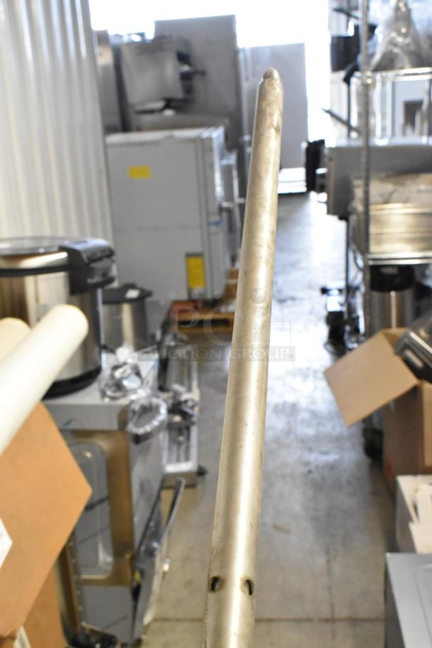 Two metallic hoses in a storage area, showing wear. Auction item offers two hoses per bid.