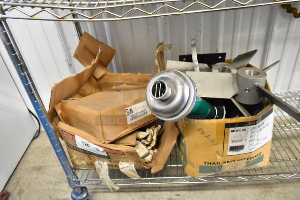 Two boxes containing Prince RD-150-16 and RD522CCAA5A4B1 parts on a metal shelf; labels visible, condition used.