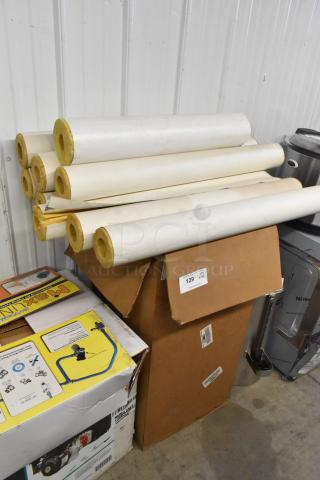 Lot of items including rolls of insulation and assorted boxed materials, visible item number 129.