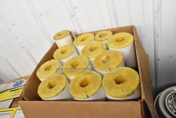 Box of yellow insulation rolls, various sizes, in a cardboard box. Used condition, for auction as part of mixed item lot.
