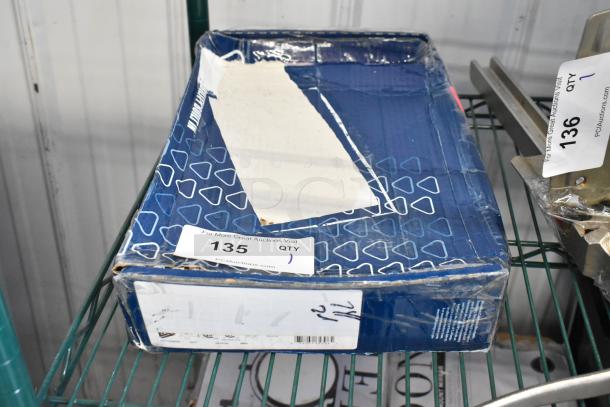 Brand new T&S faucet in damaged box, labeled "Scratch and Dent." Auction tag "135" visible.