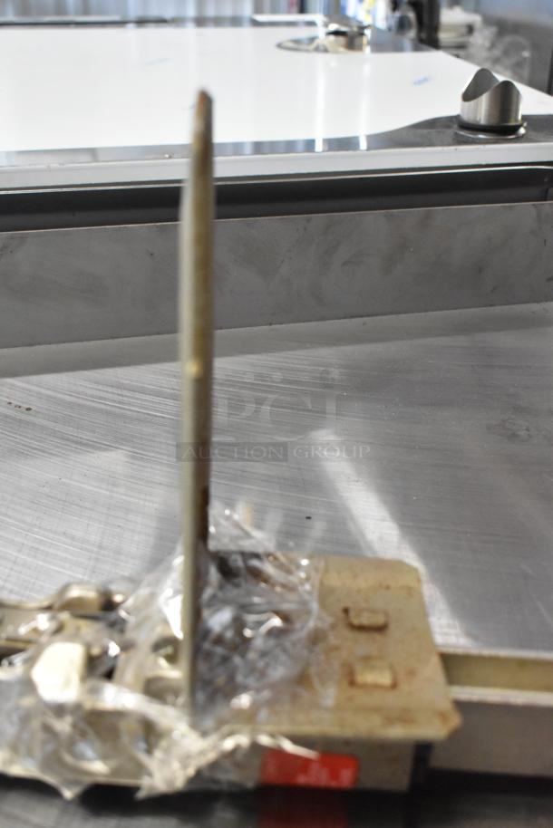 BRAND NEW Edlund 905 Metal Commercial Can Opener with mount, visible scratches and dents, wrapped in plastic.