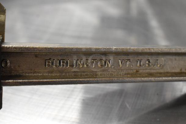 Edlund 905 metal commercial can opener, brand new with scratches and dents, features a mounting base. Marked "BURLINGTON, VT. U.S.A."