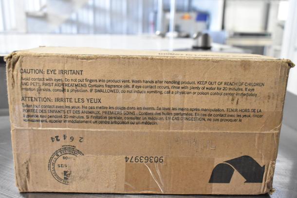 Cardboard box labeled with cautionary text for Febreze Double Plug In Replacements. Box appears scratched and dented.