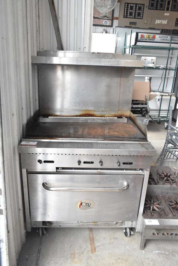 Cooking Performance Group stainless steel commercial gas flat top griddle with oven, overshelf, backsplash, on casters.