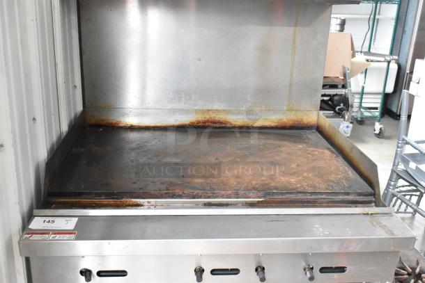 Cooking Performance Group stainless steel gas flat top griddle with oven, overshelf, and backsplash on casters. Used condition.