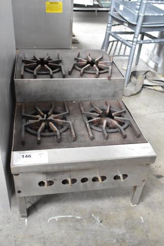 Metal commercial countertop gas-powered range with 4 burners on a 2-tier design. Moderate wear, auction tag 146 visible.