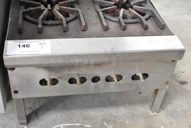 Metal commercial countertop gas-powered 4 burner, 2-tier range. Used condition with visible wear. Label states item 146.