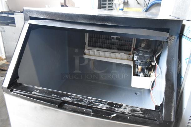 Manitowoc QY0134A stainless steel undercounter ice machine, open view showing interior condition and components.