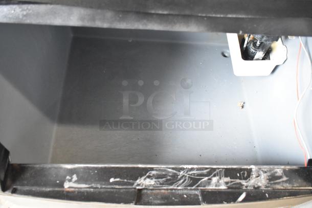 Manitowoc QY0134A stainless steel ice machine interior, showing undercounter design. Appears in used condition.