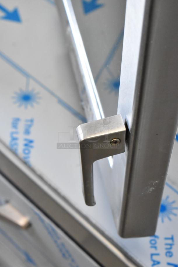 2018 Menumaster MRC30S2 stainless steel commercial microwave handle, showing a sturdy metal finish.
