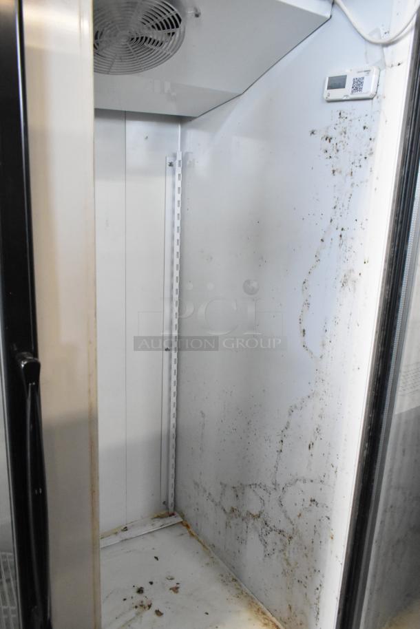 Master-Bilt BLG-48HD commercial freezer interior with visible shelving, fan, control panel, and signs of wear.