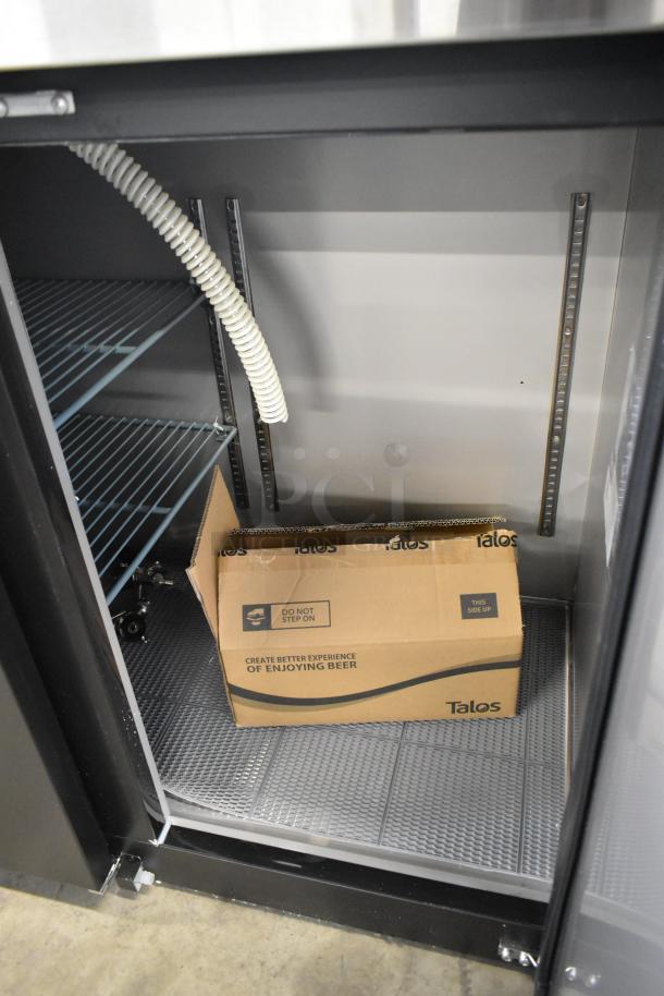 Brand new metal commercial kegerator, 115 volts, 1 phase, scratch and dent condition, interior shelving and wiring visible.