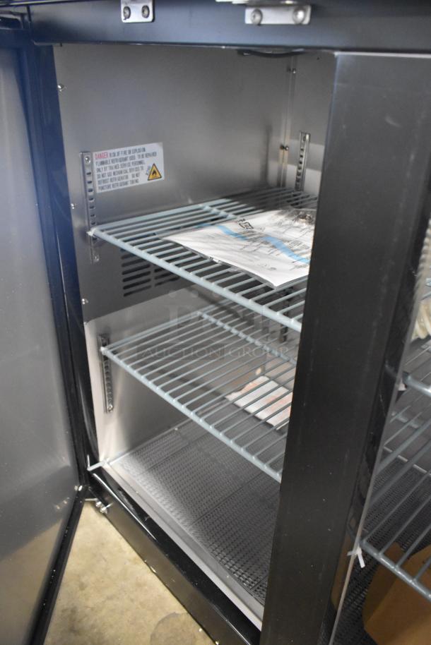 Brand new metal commercial kegerator, direct draw, 115 volts, 1 phase, with visible interior shelves and caution label.