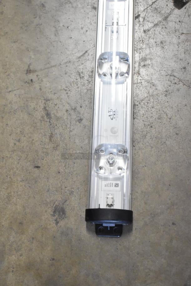 Anthony Optimax 2 LED light strip, new condition, features clear housing with visible LEDs and mounting brackets.