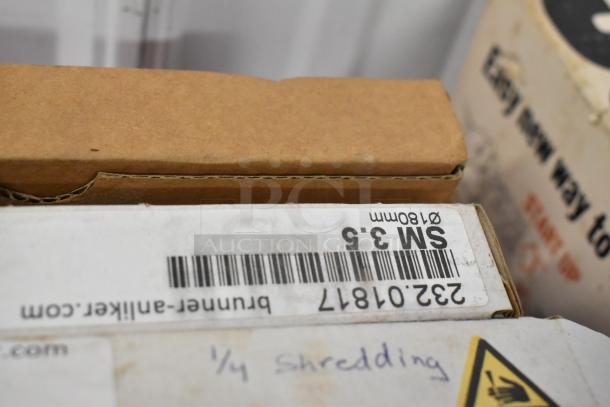 11 new Brunner Anliker food processor blades in box. Label reads "SM 3.5, Ø180mm." Barcode: 232-07817.