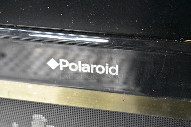 Polaroid 3211-TLXB TV, black, good condition. Polaroid logo visible. Requires 100-240V, 1 phase. Pickup only.