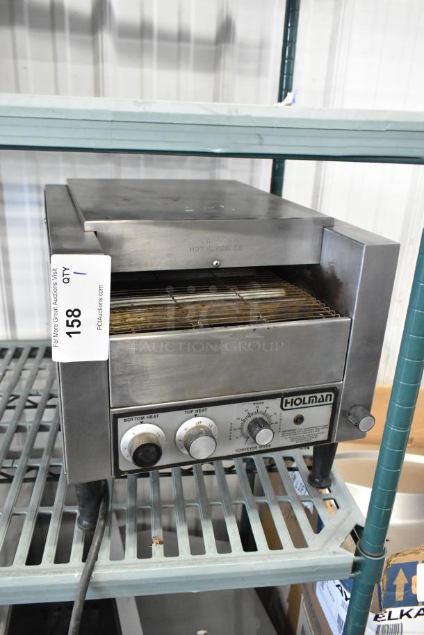 Holman stainless steel commercial countertop conveyor toaster oven, 115 volts, 1 phase, visible controls, and power cord.