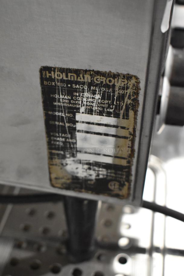 Holman Stainless Steel Commercial Conveyor Toaster Oven, 115V, visible wear on label detailing model and serial numbers.