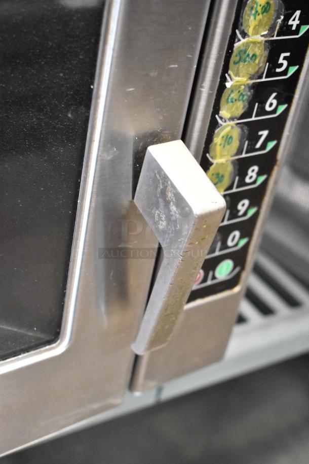 Menumaster MRC30S2 stainless steel commercial microwave oven, showing control panel and handle, in used condition.