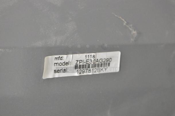 ZPI-E30AG290 Metal Range Hood label showing model and serial number 1297812BKY. Visible light scuffs on the surface.