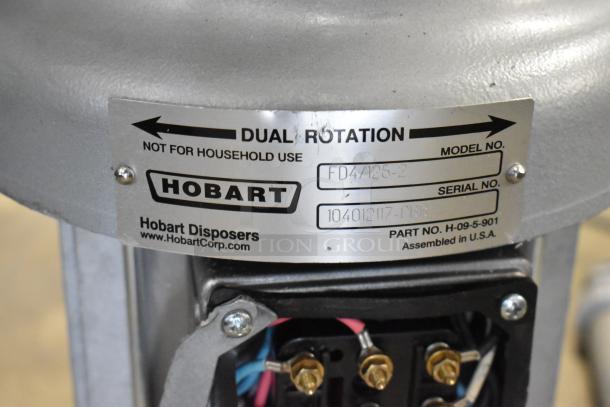 Hobart FD4/125-2 commercial garbage disposer, 1 1/4 hp, 208-240/480V; features long upper housing; "dual rotation" label.