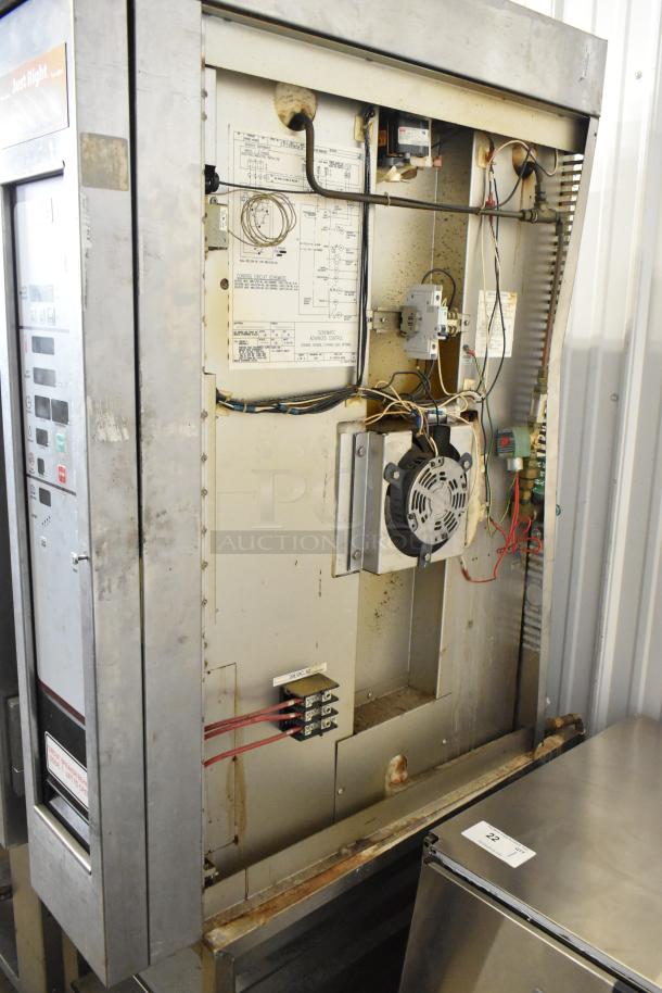 Baxter Stainless Steel Commercial Electric Mini Rotating Rack Oven with Dual Pan Rack and Casters, showing internal wiring and components.