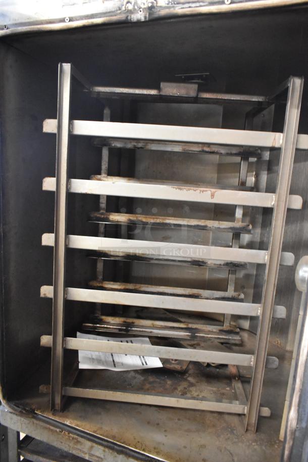 Baxter stainless steel mini rotating rack oven, dual pan rack, used condition, visible wear, with commercial casters.
