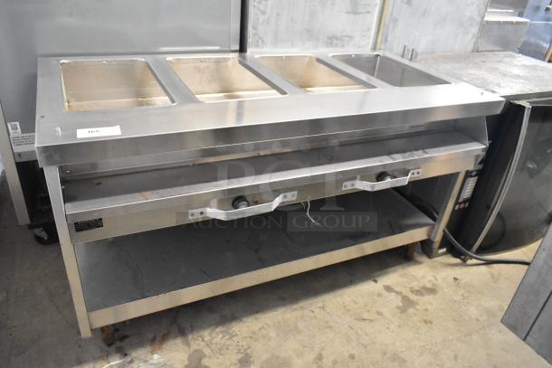 Stainless steel commercial electric steam table, 208 volts, with three compartments and control knobs, in good condition.