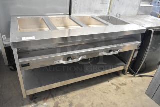 Stainless steel commercial electric steam table, 208 volts, with three compartments and control knobs, in good condition.
