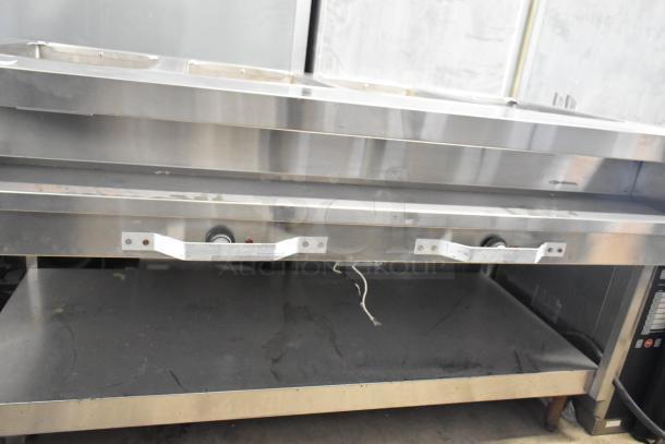 Stainless steel commercial electric steam table, 208 volts, dual control knobs, minor surface wear, suitable for food service.