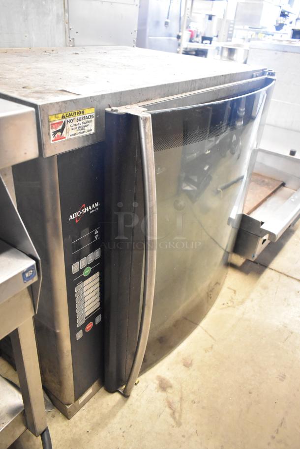 Alto Shaam AR-7E rotisserie oven, stainless steel, electric-powered, visible control panel, caution label on top.